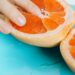 Person Touching Sliced Orange Fruit