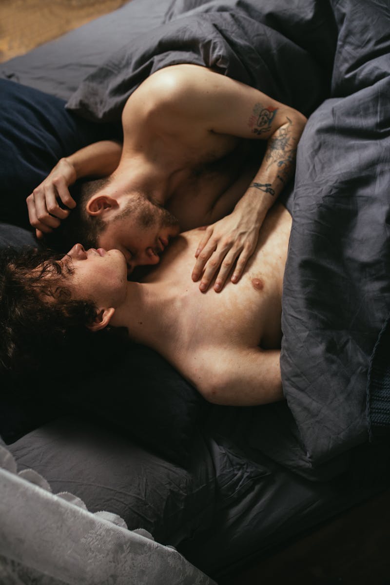 Shirtless Men Lying on Bed